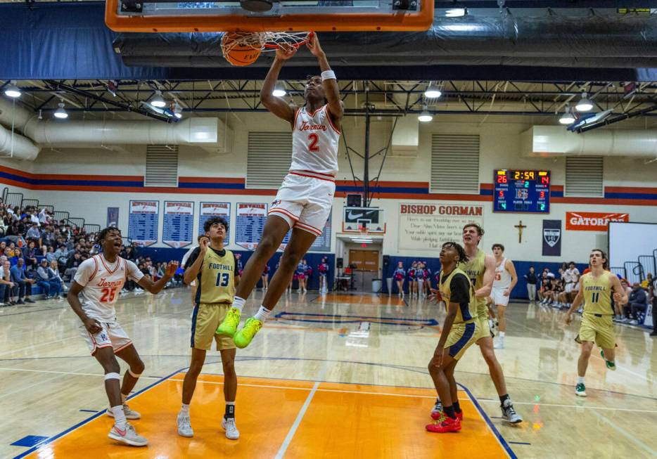 Bishop Gorman's Jett Washington (2) dunks the ball as Foothill's Branden Castro (13) and teamma ...