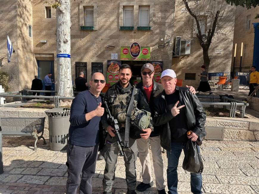 Comics Peter Berman, Brian Kiley and Butch Bradley are shown with an Israeli soldier during the ...