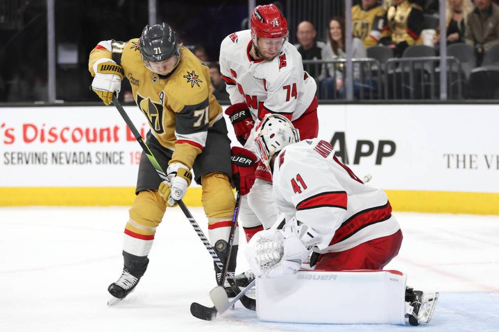 Golden Knights center William Karlsson (71) battles with Hurricanes defenseman Jaccob Slavin (7 ...