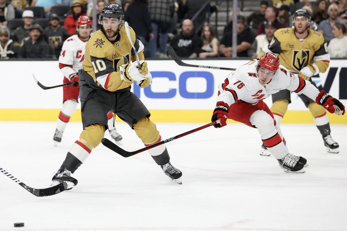 Golden Knights center Nicolas Roy (10) passed the puck while Hurricanes defenseman Brady Skjei ...