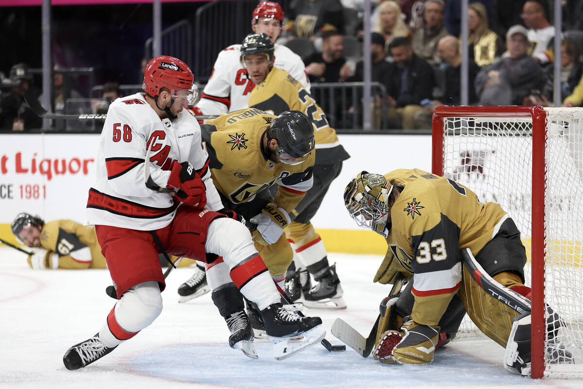 Golden Knights goaltender Adin Hill (33) and defenseman Alex Pietrangelo (7) keep the puck out ...