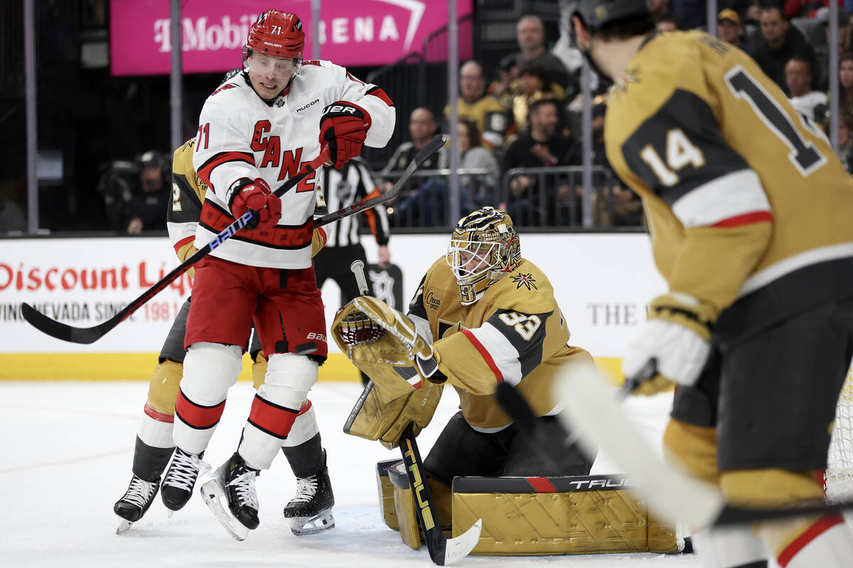 Golden Knights goaltender Adin Hill (33) prepares to make a glove save while Hurricanes right w ...