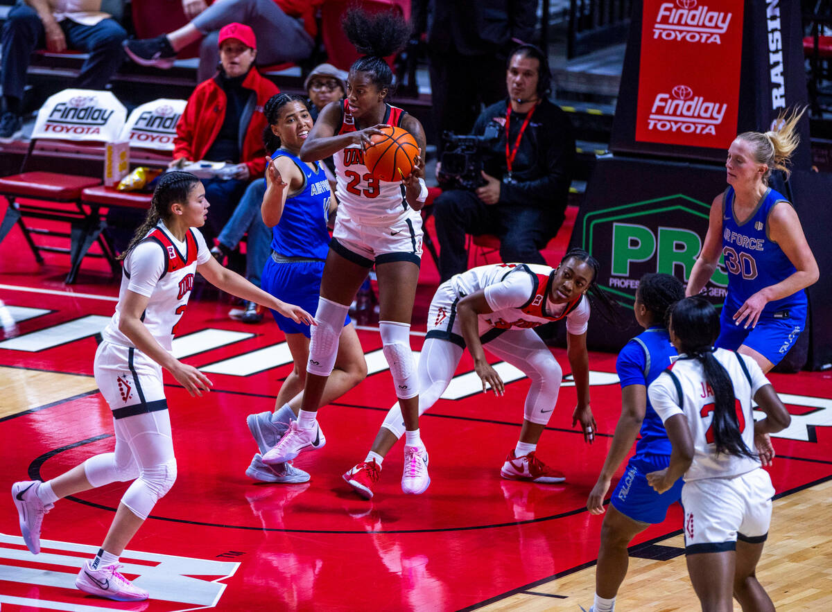 UNLV Lady Rebels center Desi-Rae Young (23) pulls down a rebound over Air Force Falcons guard J ...