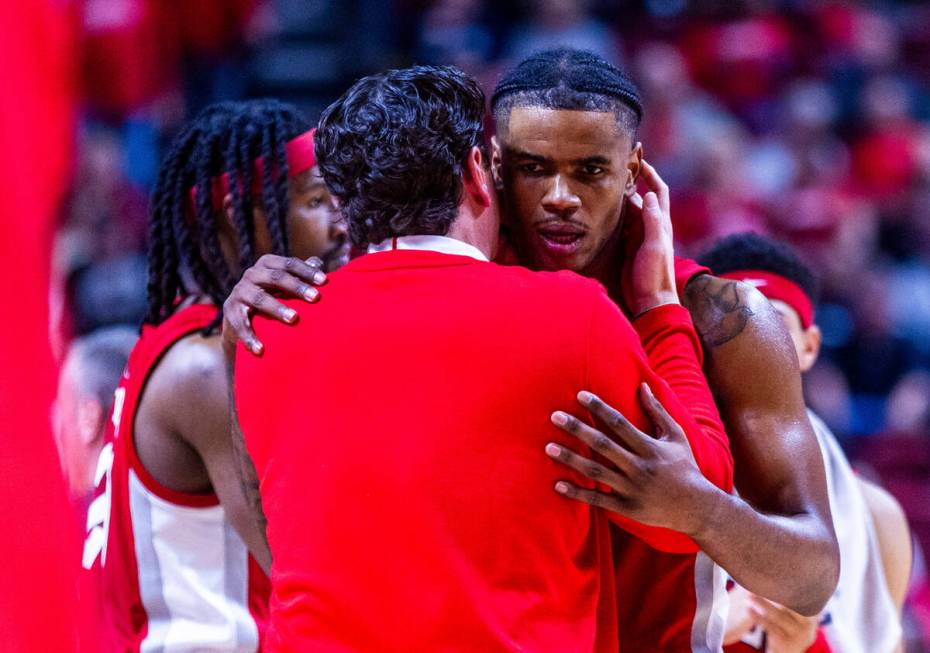 UNLV Rebels guard Luis Rodriguez (15) is counseled by a coach against UNR during the second hal ...