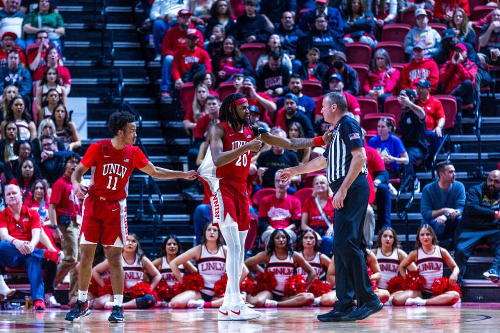 UNLV Rebels guard Dedan Thomas Jr. (11) pulls back teammate forward Keylan Boone (20) saw he ar ...