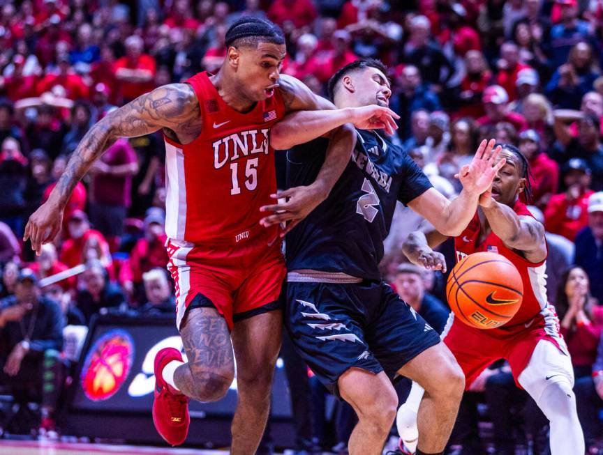 UNLV Rebels guard Luis Rodriguez (15) fouls UNR guard Jarod Lucas (2) sending him to the line l ...