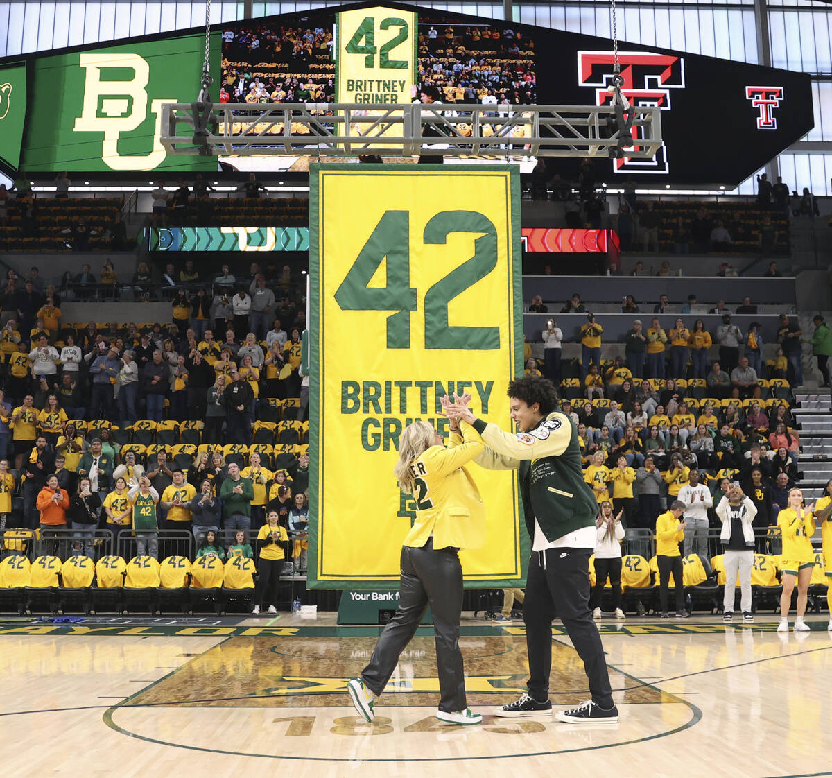 Former Baylor University legend and WNBA star Brittney Griner, right, looks on with Baylor head ...