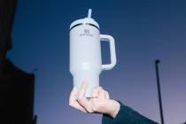 Hannah Gomez holds up her Stanley cup water bottle at USC University Village.(Dania Maxwell/Los ...