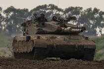 Israeli soldiers drive a tanks near the Gaza Strip border, in southern Israel, Monday, Feb. 19, ...