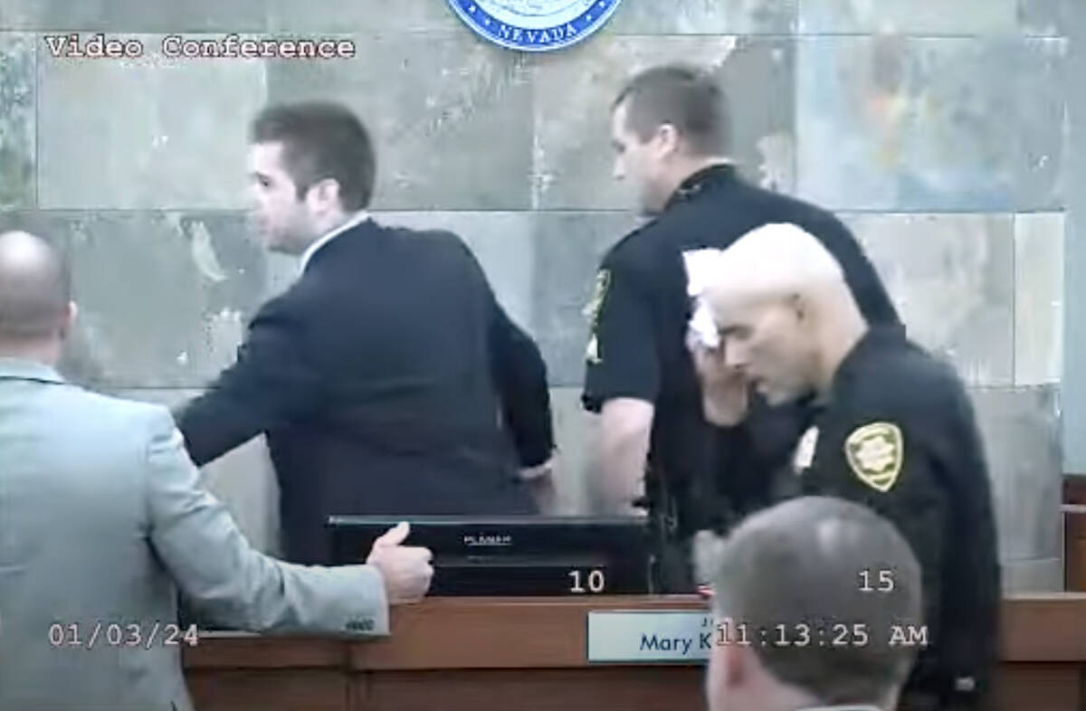 This screen shot from video shows a court marshal dabbing his forehead after defendant Deobra R ...