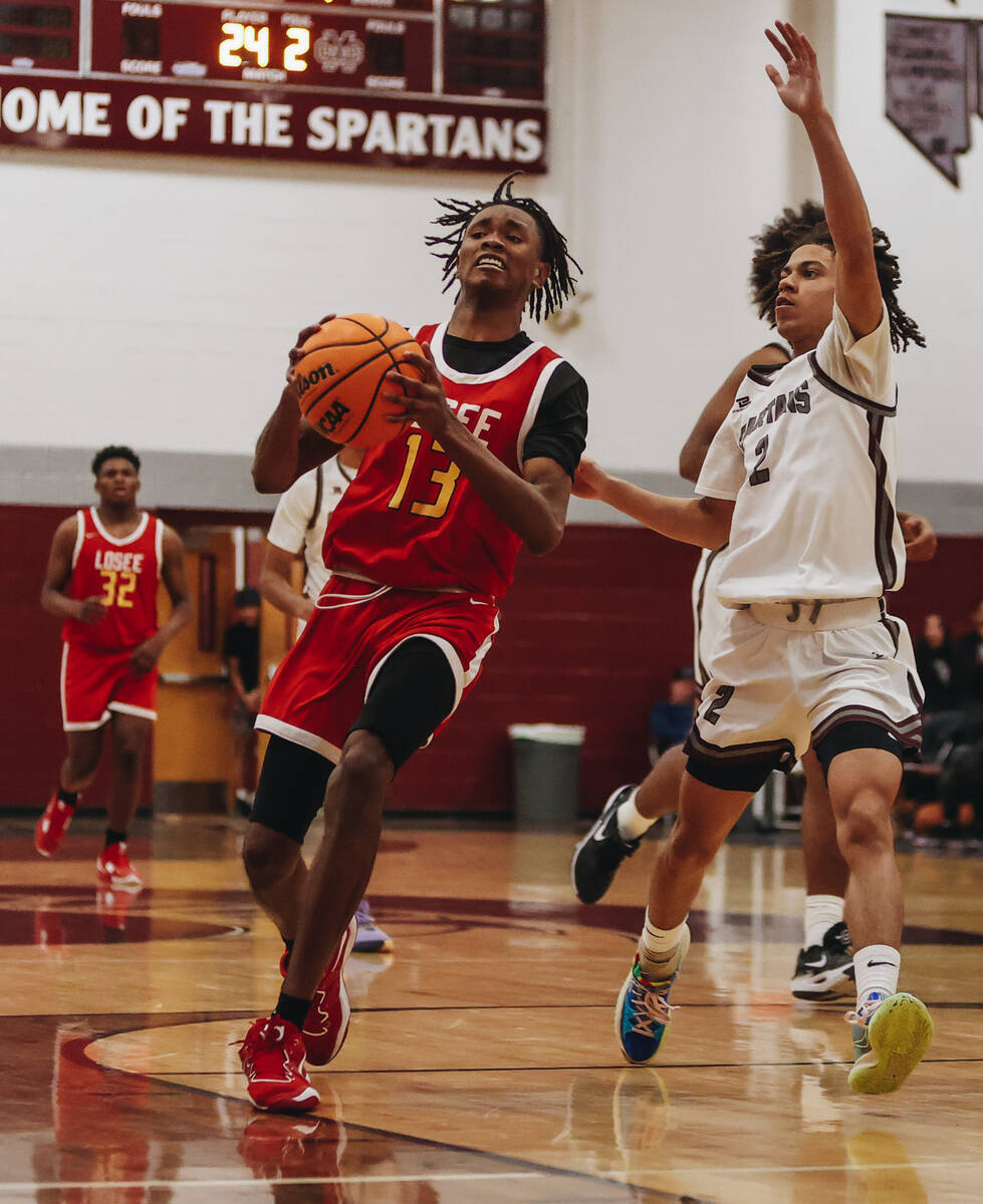 Somerset-Losee guard KeSean White (13) looks to pass the ball to a teammate during a game at Ci ...