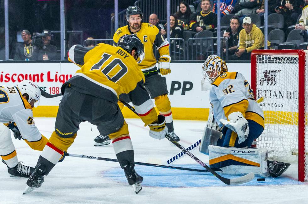 Golden Knights center Nicolas Roy (10) eyes the net as Nashville Predators goaltender Kevin Lan ...