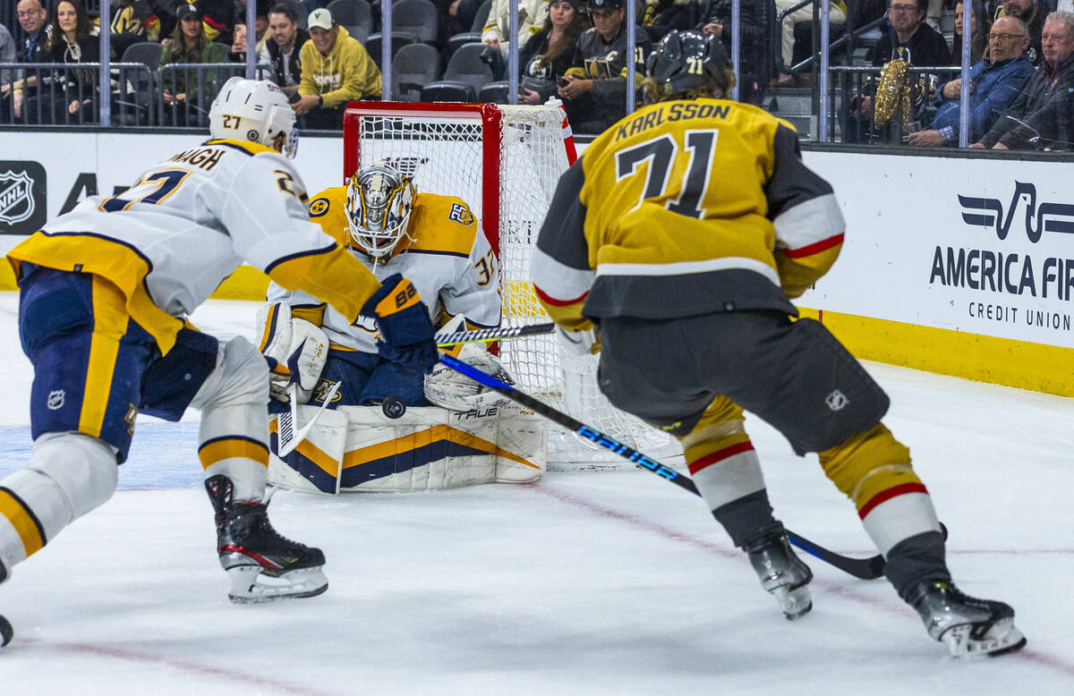 Golden Knights center William Karlsson (71) has a shot deflected by Nashville Predators goalten ...