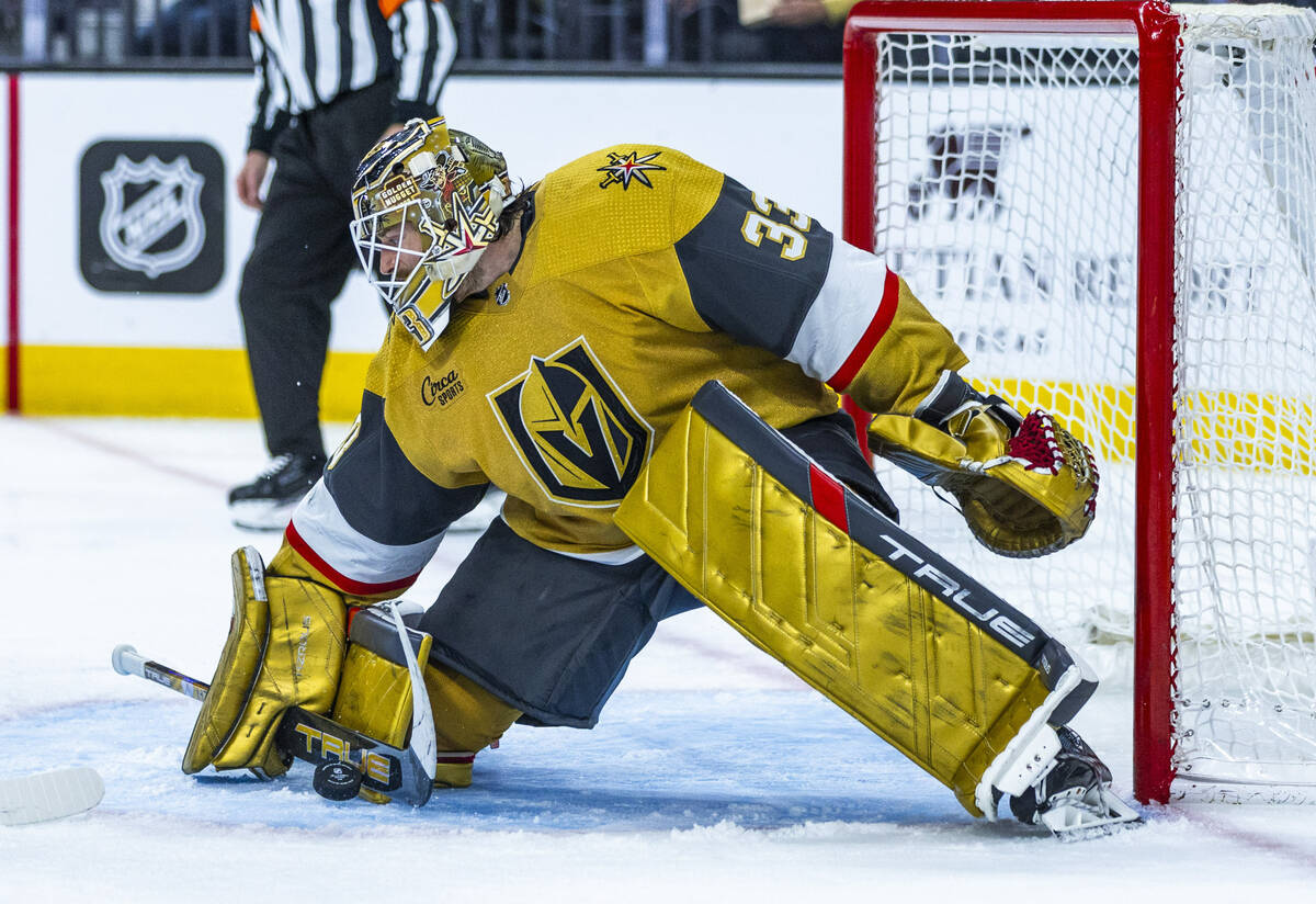 Golden Knights goaltender Adin Hill (33) stops a shot by the Nashville Predators during the sec ...