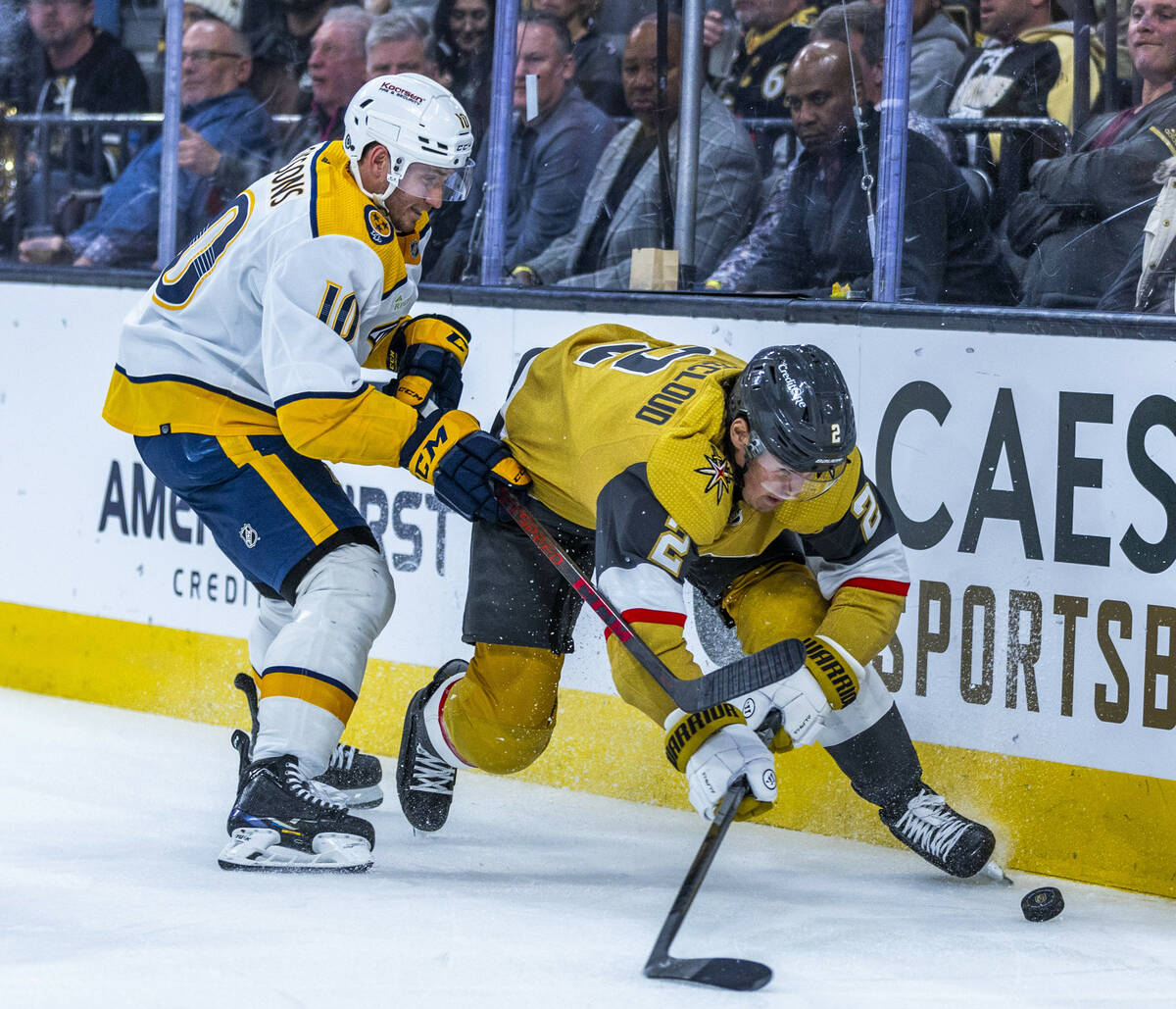 Golden Knights defenseman Zach Whitecloud (2) battles for control of the puck against Nashville ...