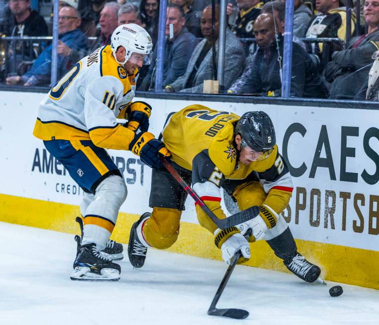 Golden Knights defenseman Zach Whitecloud (2) battles for control of the puck against Nashville ...