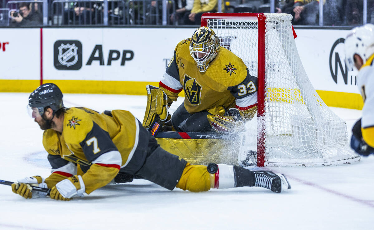 Golden Knights defenseman Alex Pietrangelo (7) dives to deflects a shot off his leg as goaltend ...