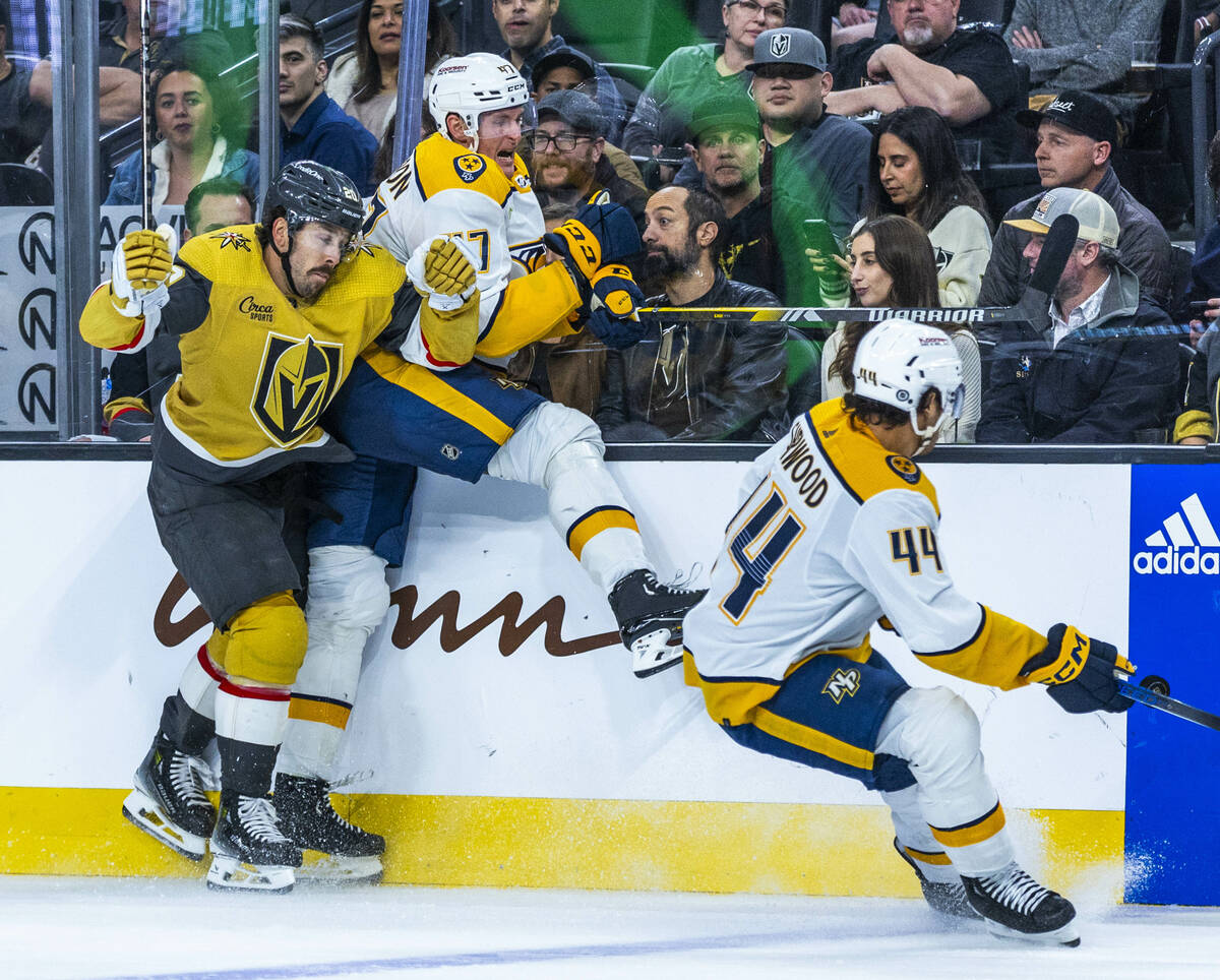 Golden Knights center Chandler Stephenson (20) checks Nashville Predators right wing Michael Mc ...