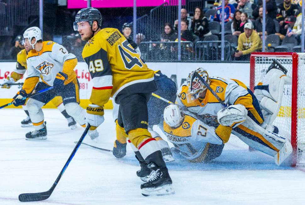 Nashville Predators defenseman Ryan McDonagh (27) crashes into goaltender Kevin Lankinen (32) a ...