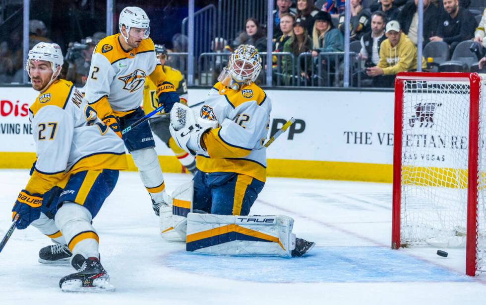 Nashville Predators goaltender Kevin Lankinen (32) watches as a puck gets past shots by Golden ...