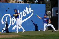 Los Angeles Dodgers pitchers Shelby Miller and Noah Syndergaard (43) warm up during the first d ...