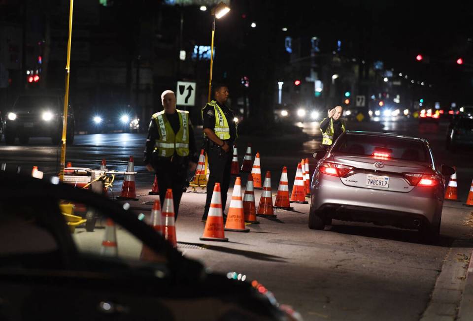 LAPD police check drivers at a DUI checkpoint in Reseda, Los Angeles, on April 13, 2018. (Mark ...