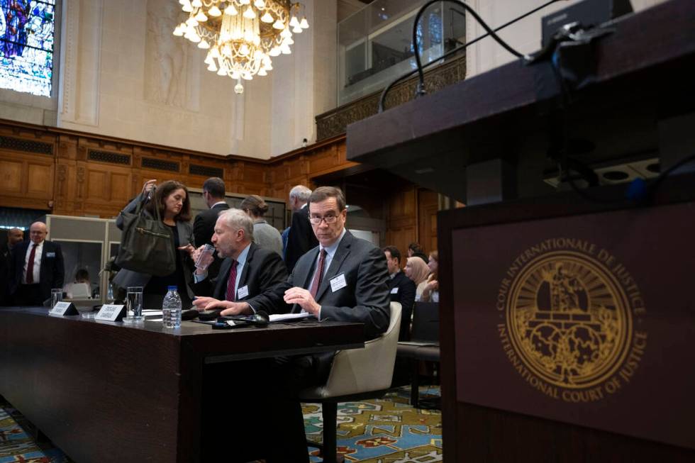 Richard C. Visek, acting legal adviser of the U.S. Department of state, center, waits to addres ...