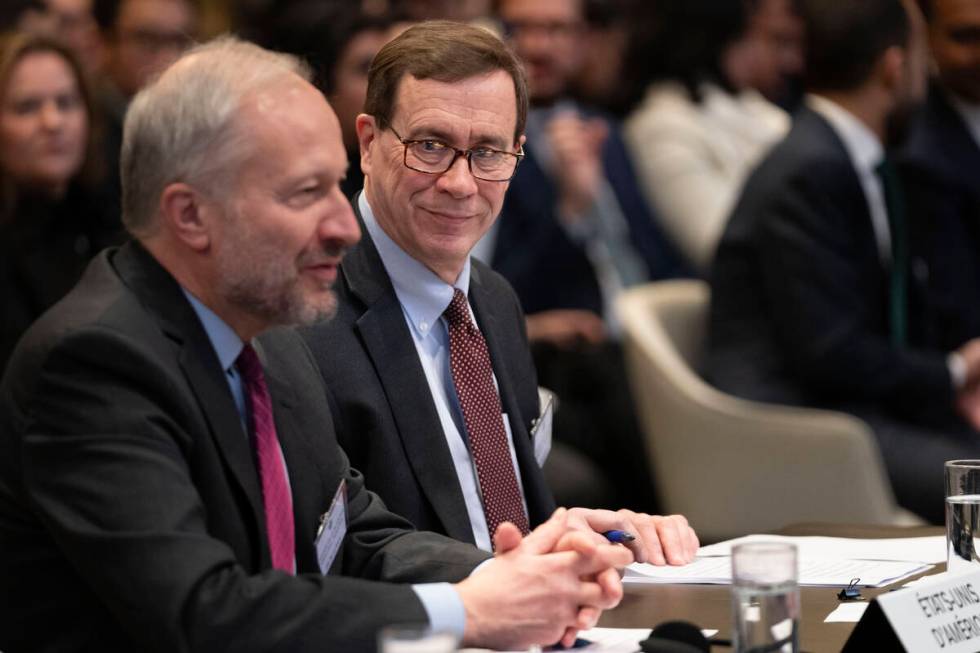 Richard C. Visek, acting legal adviser of the U.S. Department of state, second left, waits to a ...