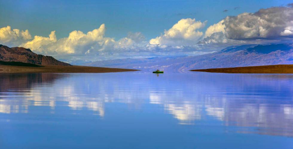 A visitor kayaks on the temporary Lake Manly at Badwater Basin in Death Valley National Park on ...