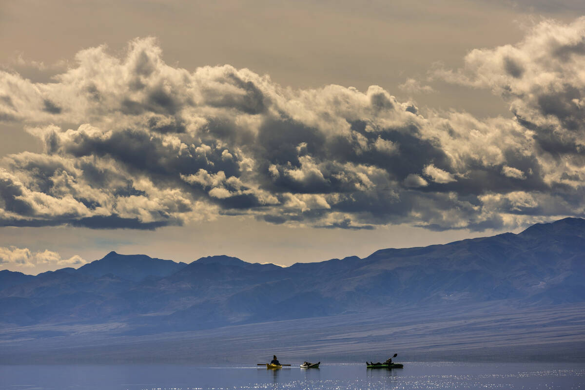 People kayak on the temporary Lake Manly at Badwater Basin in Death Valley National Park on Wed ...