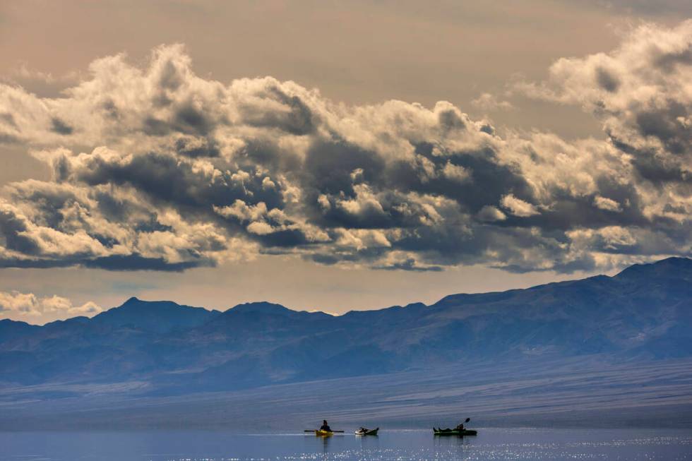 People kayak on the temporary Lake Manly at Badwater Basin in Death Valley National Park on Wed ...