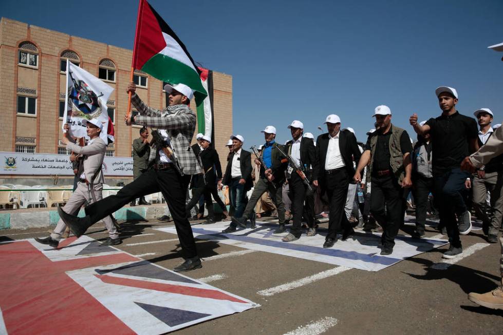 Newly recruited Houthi fighters attend a protest march against the U.S.-led strikes on Yemen an ...