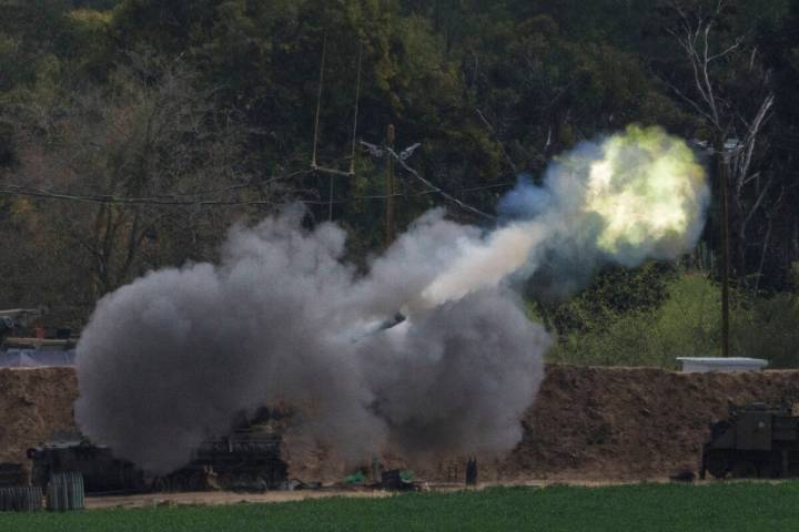 An Israeli mobile artillery unit fires a shell from southern Israel towards the Gaza Strip, in ...