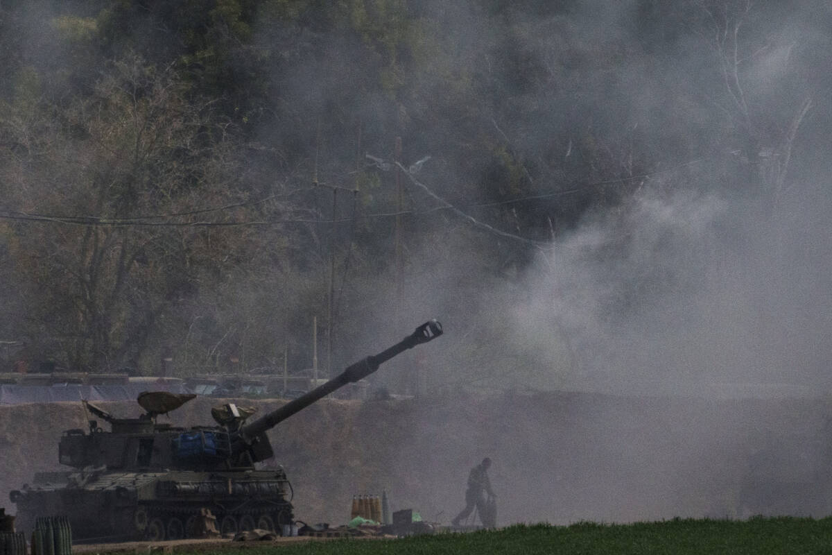 An Israeli mobile artillery unit fires a shell from southern Israel towards the Gaza Strip, in ...