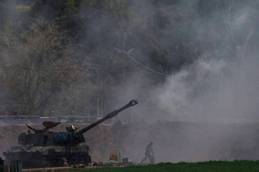 An Israeli mobile artillery unit fires a shell from southern Israel towards the Gaza Strip, in ...