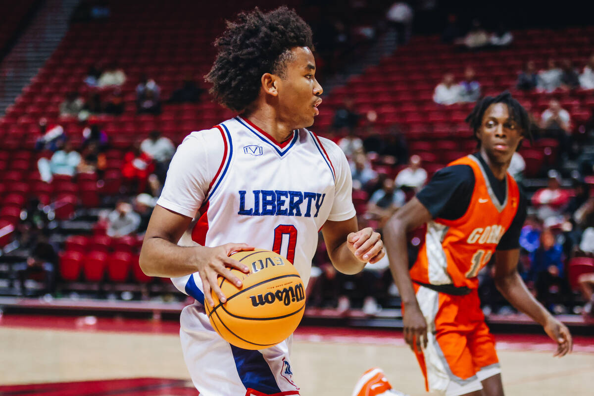 Liberty point guard Tyus Thomas (0) dribbles the ball down the court during a Class 5A boys bas ...