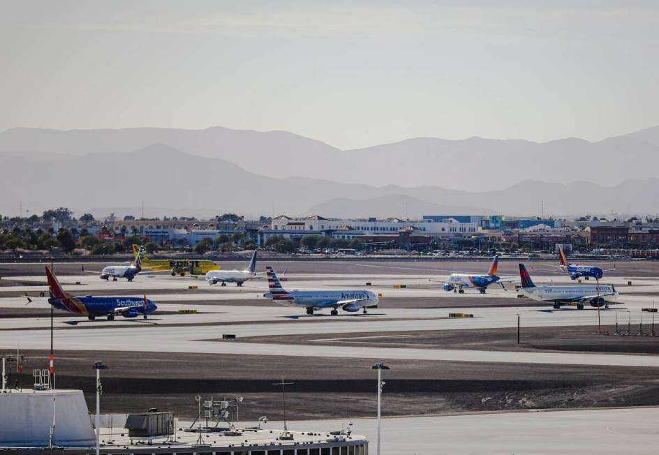 Planes wait in a line to take off on the tarmac at Harry Reid International Airport in Las Vega ...