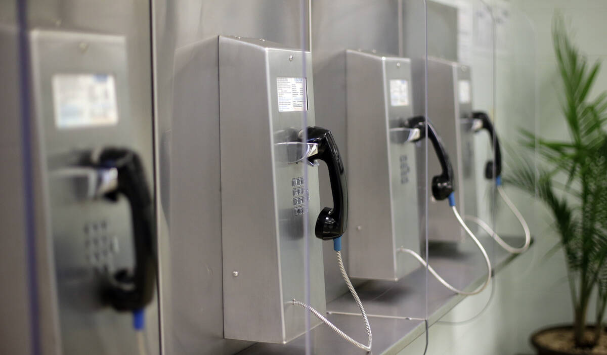 A bank of phones are seen at the Karnes County Residential Center, Thursday, July 31, 2014, in ...