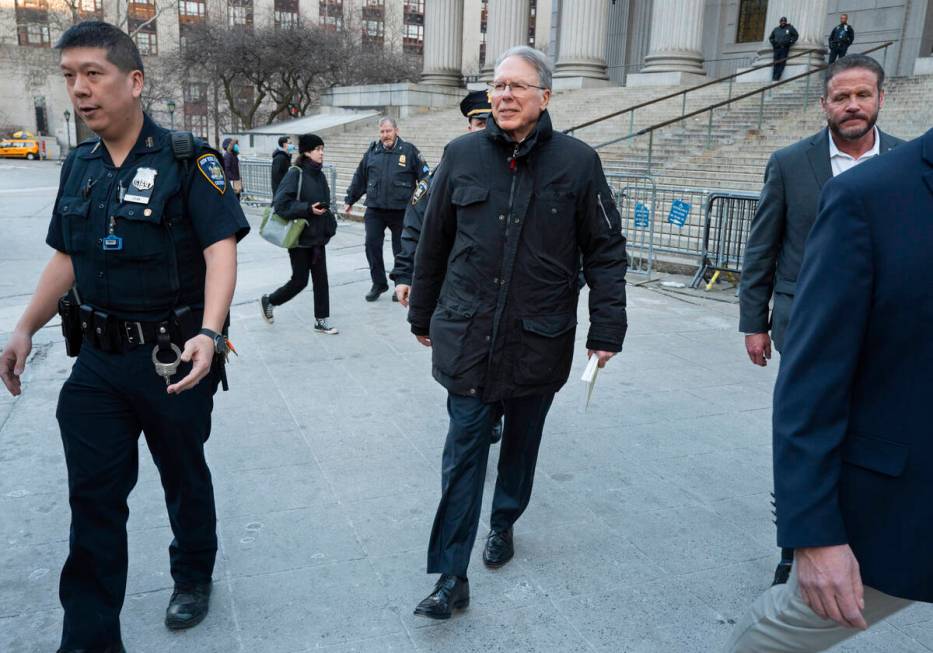 Wayne LaPierre, center, CEO of the National Rifle Association, leaves the courthouse as a jury ...