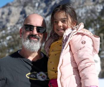 Duane Serge and his daughter, Sofia Serge, pose after youth ski and snowboard lessons at Lee Ca ...