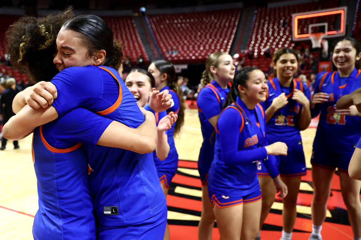 Bishop Gorman's Aaliah Spaight (10) and Savannah Searcy (32) embrace after winning the Class 5A ...
