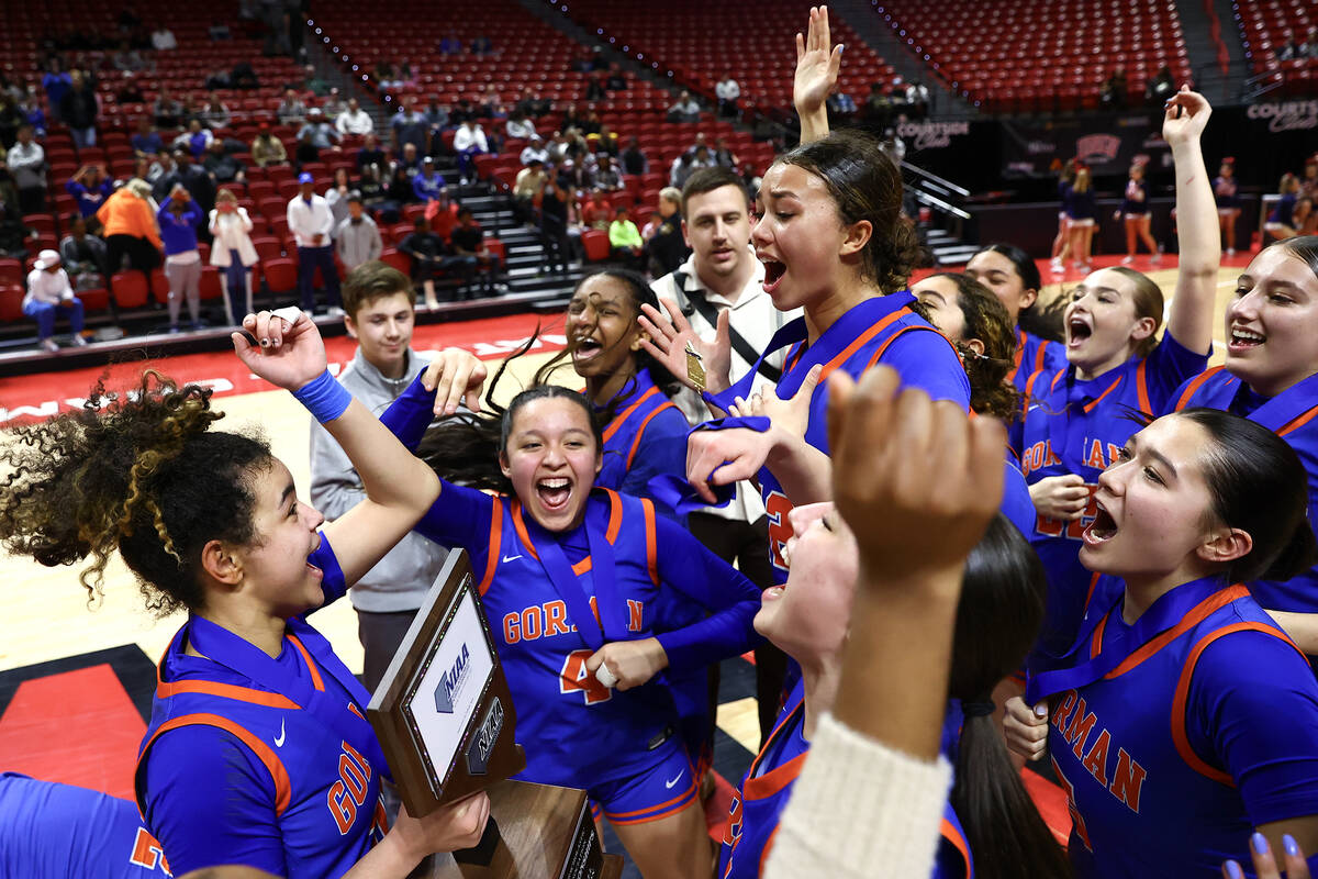 Bishop Gorman celebrates with their trophy after defeating Centennial in the Class 5A girls bas ...
