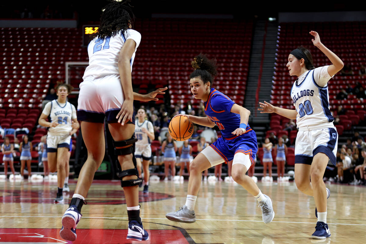 Bishop Gorman's Aaliah Spaight (10) drives toward the hoop against Centennial's Cici Ajomale (2 ...