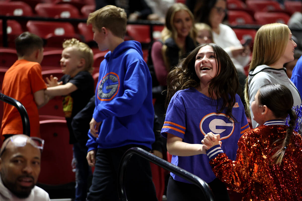 Bishop Gorman fans cheer as their team takes a late lead during the second half of the Class 5A ...