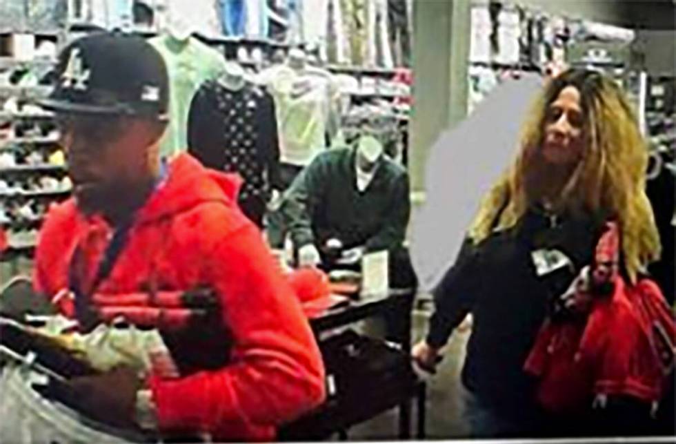 The two armed robbery suspects stealing merchandise at a business near the 2000 block of East S ...