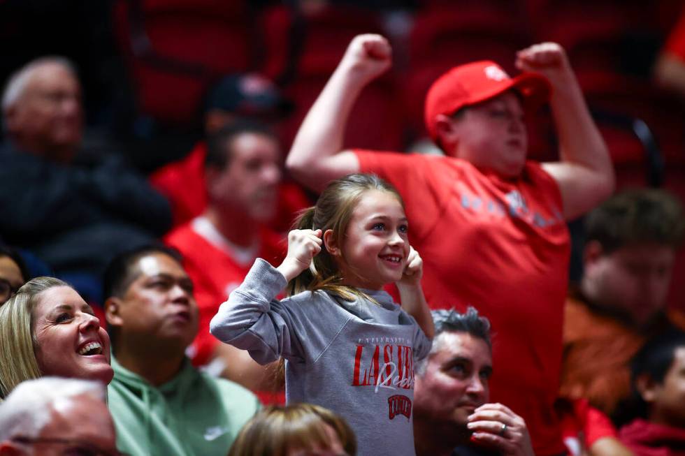 Young UNLV Rebels fans show their strength for the big screen during the first half of an NCAA ...