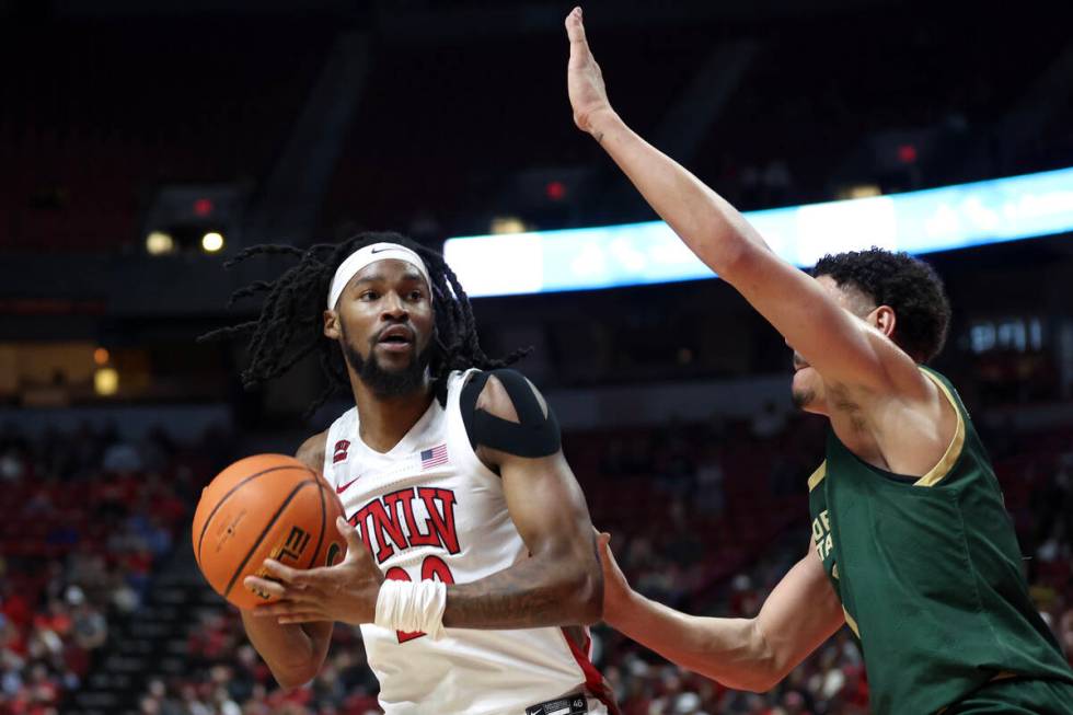 UNLV Rebels forward Keylan Boone (20) looks to pass against Colorado State Rams guard Nique Cli ...