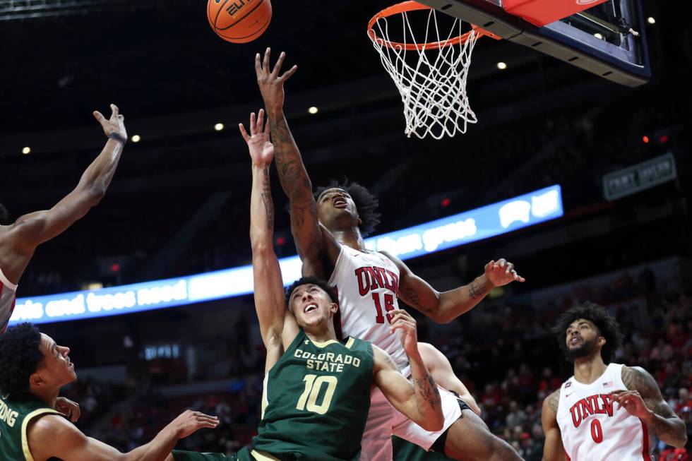 UNLV Rebels guard Luis Rodriguez (15) shoots against Colorado State Rams guard Nique Clifford ( ...