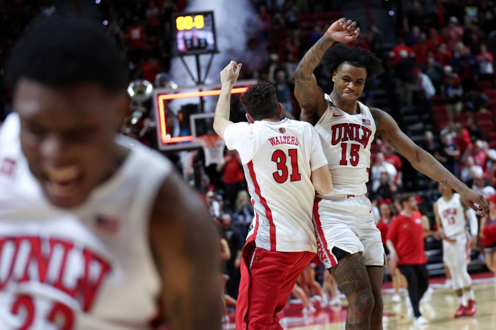 UNLV Rebels guard Luis Rodriguez (15) celebrates with guard Nick Walters (31) after they won an ...