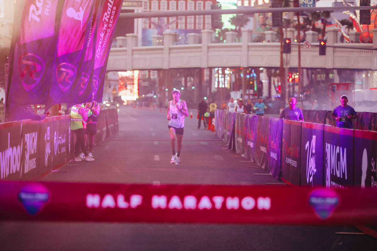 Andy Wacker, the first place winner for the men’s half marathon, runs to the finish line ...